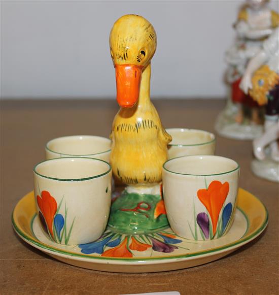 A Clarice Cliff crocus pattern duck egg cup stand and 4 cups
